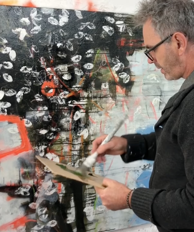 Lewis Noble painting in his studio